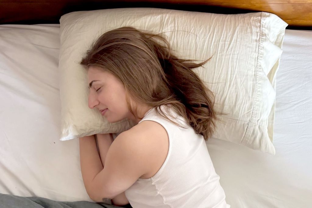 Queen pillows designed for side, back, and stomach sleepers on a neatly made bed.